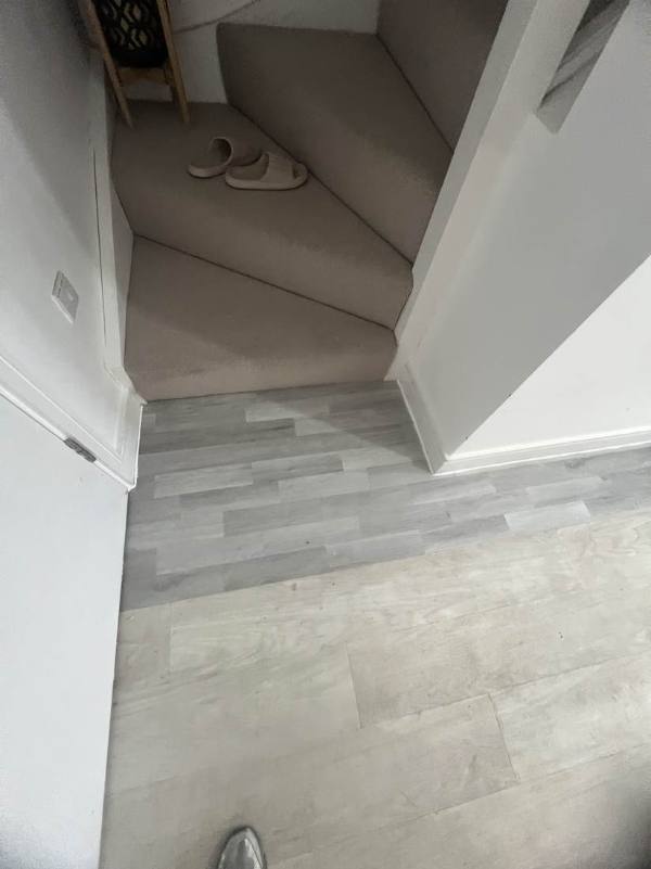 The same hallway with new grey flooring laid