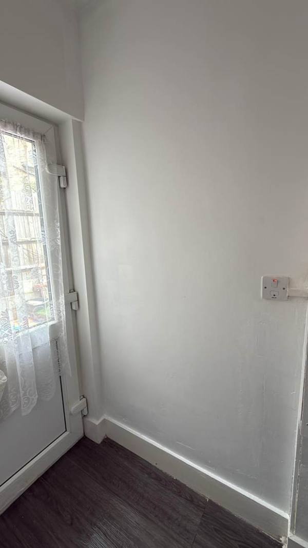 Clean, freshly painted hallway after the void works